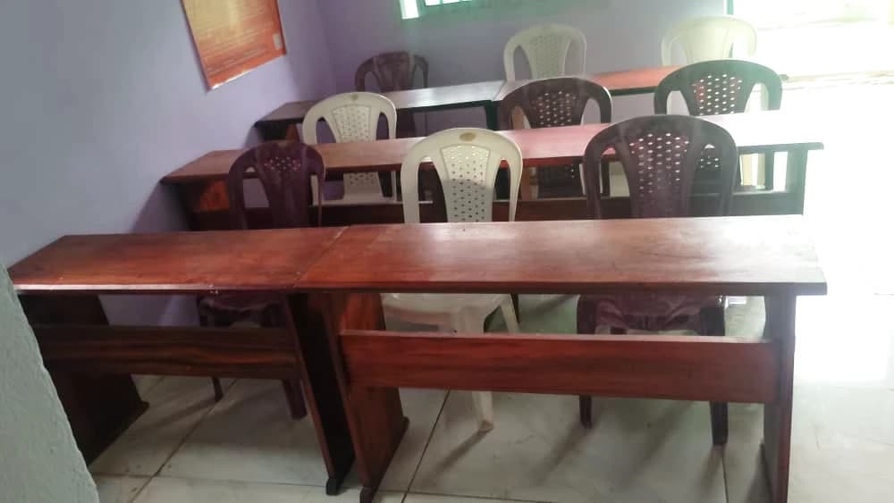 Homework School classroom in Nkolmesseng: wooden desks and first chairs ready for the children
