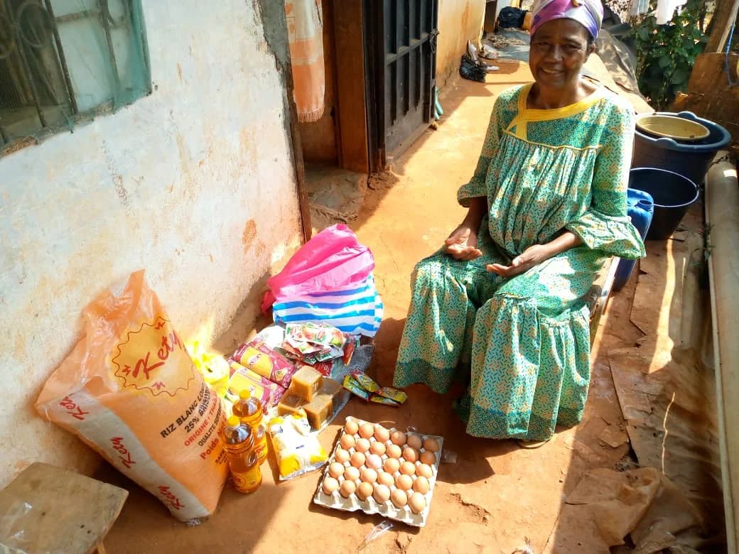 Mrs Essome with the food aid received in Yaoundé