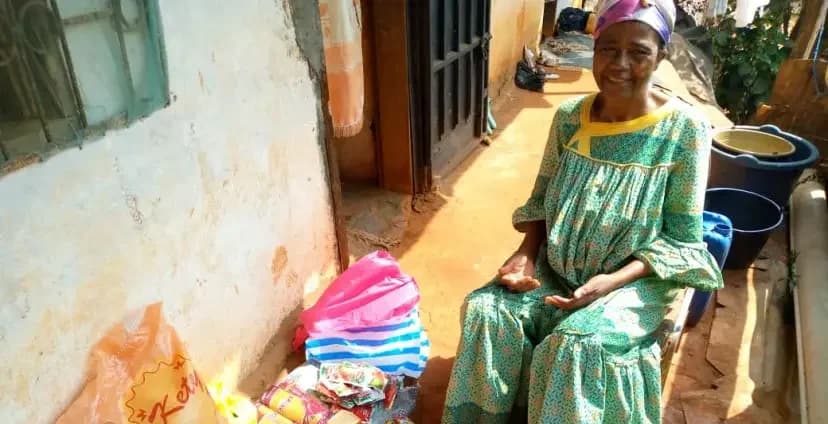 Mrs Essome with the food supplies received during the aid mission in Yaoundé