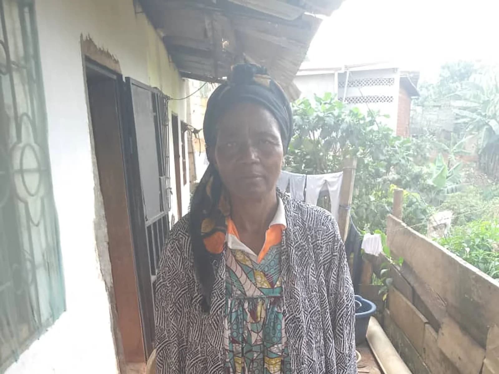Mrs Essome outside her home in Yaoundé